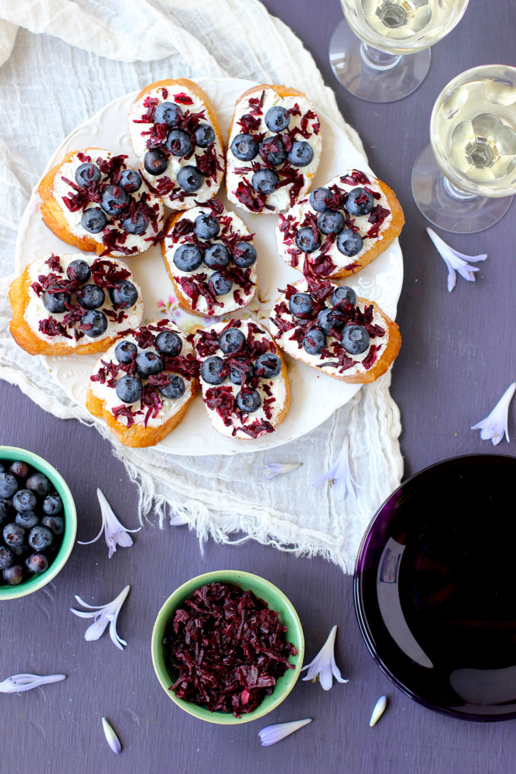 Blueberry Chevre Crostini with Champagne Vinegar Hibiscus Flowers