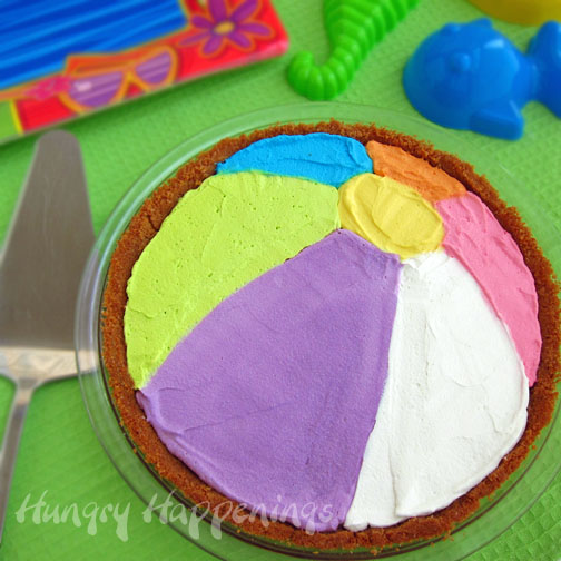 Decorate a pie to look like a beach ball using colored whipped topping