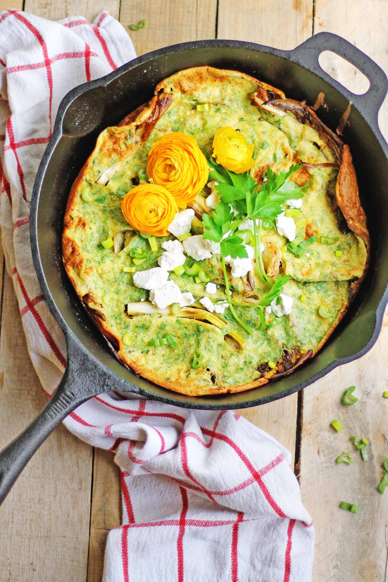 Spring onion dutch baby with herbs and goat cheese 