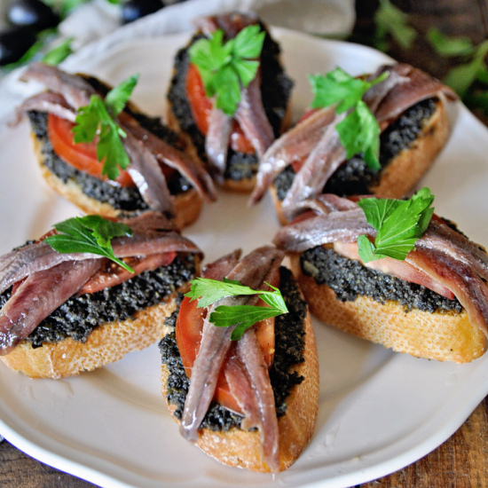 Spanish Montaditos with Black Olive Tapenade and Anchovies