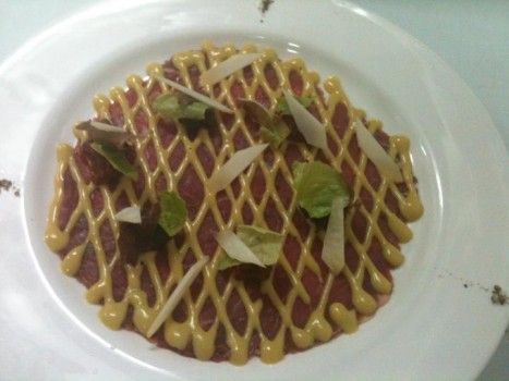 Lime marinated beef carpaccio with black olive tapenade and sun-dried tomato pesto