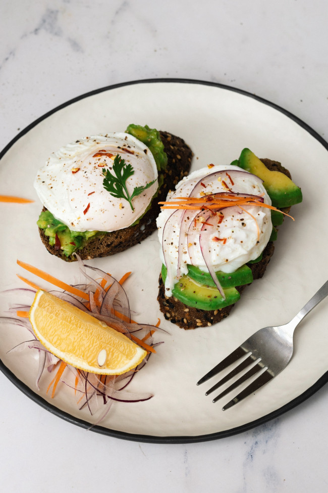An Avocado Toast Recipe With Poached Egg That Bursts When Sliced Into