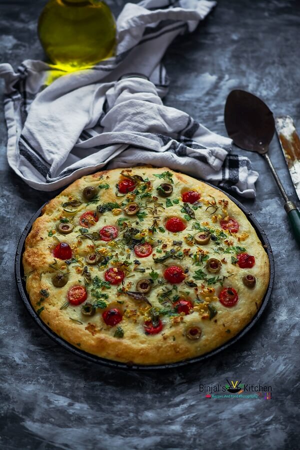 herbed focaccia bread with olive and cherry tomatoes